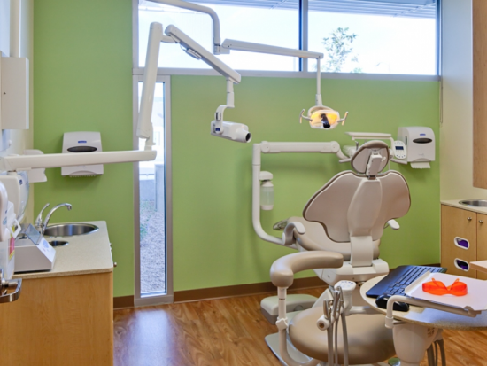 Dental operatory with backlit image and clear story glazing for positive distractions and daylighting in every operatory.